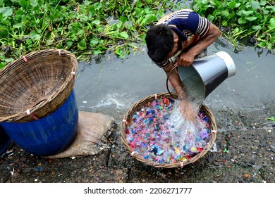 
Worker Washes Recycled Plastic Chips In The River Buriganga In Dhaka, Bangladesh, On September 25, 2022. 