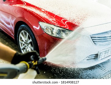 Worker Washing Car With Active Foam On A Car Wash.