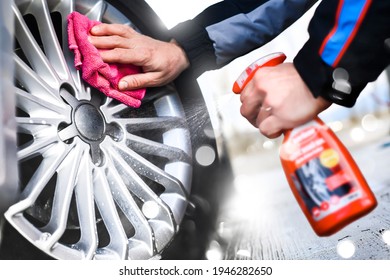 Worker Washing Car's Alloy Or Alluminium Wheels Using Cleaning Spray On A Car Wash. Rims Detailing 