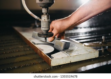 Worker At Water Jet Cutter Machine Takes Out Cut Section