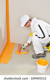 Worker Waterproofing Around The Wall, Floor And Siphon Of Bathroom