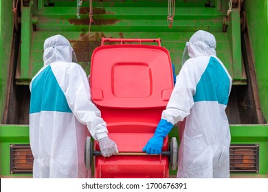 Worker Wear PPE Protective Clothing Against Corona Virus Of Infectious Waste Garbage Collector Truck Loading Waste And Trash Bin.
