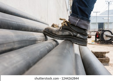 Worker Wear Safety Shoes On Hdpe Pipe. 