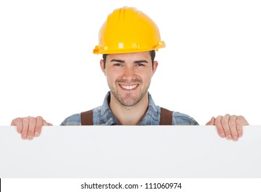 Worker wearing hard hat and holding empty banner. Isolated on white - Powered by Shutterstock