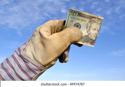 Worker Wearing Leather Work Glove Holding A Twenty Dollar Bill