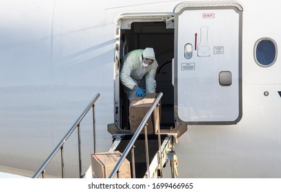 A Worker Wearing A Protective Gear Unloads Personal Protection Equipment From A Plane, To Prevent The Spread Of The Coronavirus Disease (COVID-19), In Riga, Latvia April 10, 2020. 