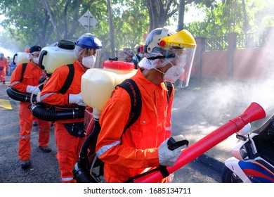 A Worker Wearing A Protective Suit And A Mask Sprays Disinfectant At A Sri Petaling Mosque Outside Kuala Lumpur, Malaysia, On Saturday, March 28, 2020