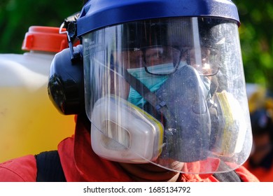 A Worker Wearing A Protective Suit And A Mask Sprays Disinfectant At A Sri Petaling Mosque Outside Kuala Lumpur, Malaysia, On Saturday, March 28, 2020