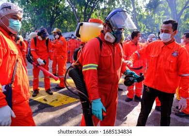 A Worker Wearing A Protective Suit And A Mask Sprays Disinfectant At A Sri Petaling Mosque Outside Kuala Lumpur, Malaysia, On Saturday, March 28, 2020