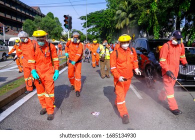 A Worker Wearing A Protective Suit And A Mask Sprays Disinfectant At A Sri Petaling Mosque Outside Kuala Lumpur, Malaysia, On Saturday, March 28, 2020