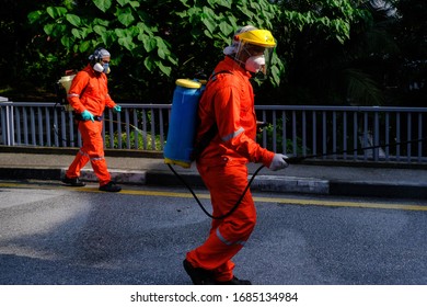 A Worker Wearing A Protective Suit And A Mask Sprays Disinfectant At A Sri Petaling Mosque Outside Kuala Lumpur, Malaysia, On Saturday, March 28, 2020