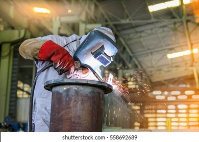 worker welder man welding steel pipe by mig in factory