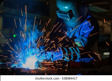 Worker is welding automotive part in  factory. - Shutterstock ID 538084417