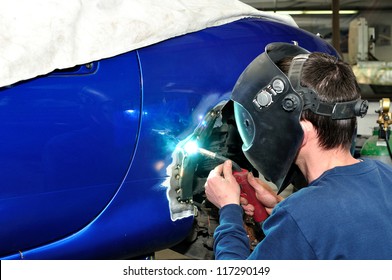 Worker Welding Car.