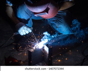 Worker Welds Metal With Safety Mask And Safety Equipments In Automotive Factory.