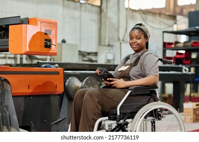 Worker in wheelchair in factory on the machine - Powered by Shutterstock