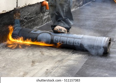 Worker While Burning The Waterproof Membrane On A Roof