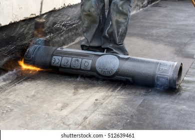 Worker While Burning The Waterproof Membrane On A Roof