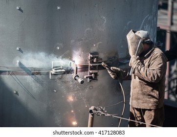 worker while doing a welding outdoor