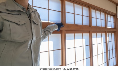A worker who adjusts the shoji screen.Japanese-style paper sliding doors. - Shutterstock ID 2112153935