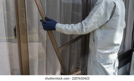 A Worker Who Installs A Screen Window.