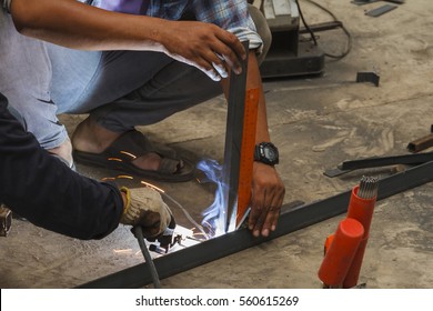 Worker without welding protective gloves welding metal - Conditions Hazardous Working.