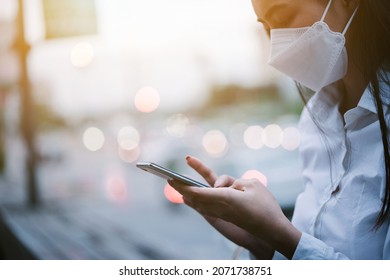 Worker Woman In A White Shirt Is Busy With Her Mobile Phone While Sitting In A Public Space In The City.