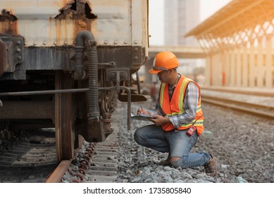 Worker Work And Check Break System Of  Train .   Engineer Man Check List Wheel System On Railways.  