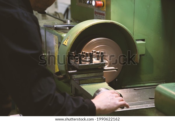 worker working on construction machine in\
industrial environment\
