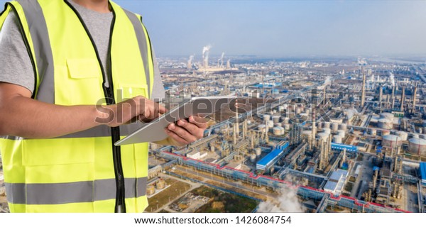 worker working on pad with oil and gas
refinery background