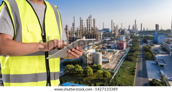 worker working on pad with oil and gas\
refinery\
background,Smart