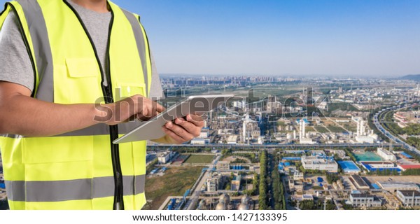 worker working on pad with oil and gas\
refinery\
background,Smart