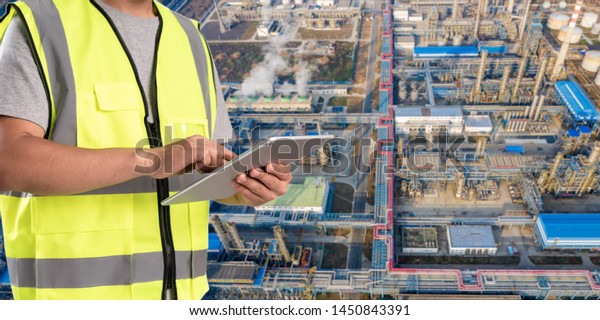 worker working on pad with oil and gas
refinery background