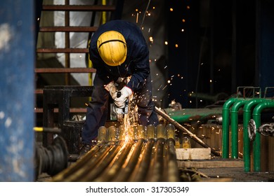 Worker working on pipes.