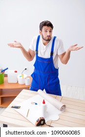 Worker Working On Wallpaper During Refurbishment