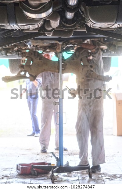 Worker works in a car\
repair station