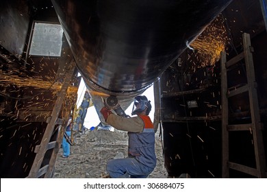 A worker works on the construction of a pipeline