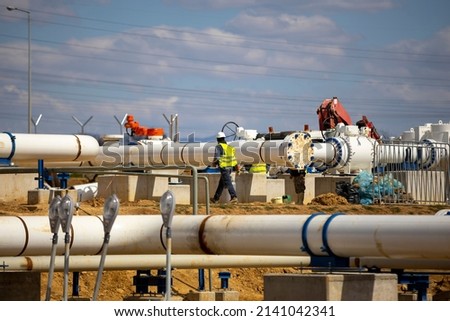 Worker works on a construction site of an interconnected natural gas transmission pipeline. Highly integrated network. Connection point between the transmission company and the receiving party.