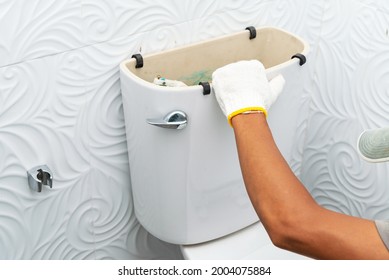 Workerman Performs Repair Of Toilet Bowl,  To Repair The Pipe From The Toilet