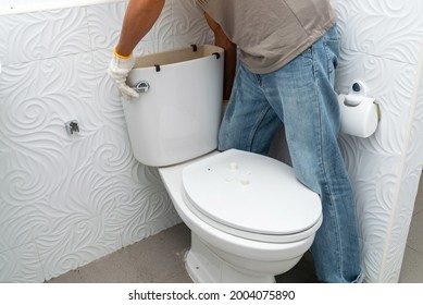 Workerman Performs Repair Of Toilet Bowl,  To Repair The Pipe From The Toilet