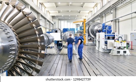 Workers Assembling And Constructing Gas Turbines In A Modern Industrial Factory