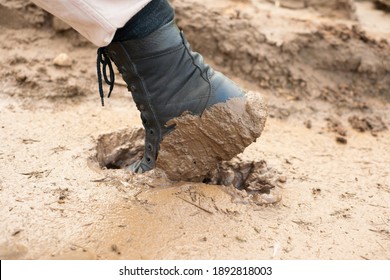 The Worker's Black Boot Was Stuck In The Mud