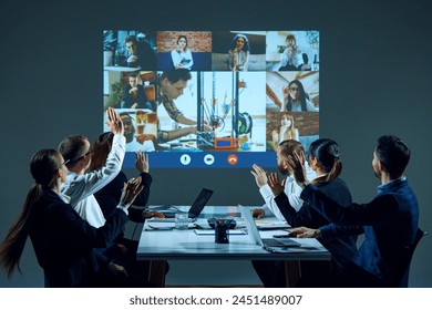 Workers in boardroom use video conferencing technology to connect with remote colleagues and facilitate collaboration. 3D printer project discussion. Business, entrepreneurship, communication, team - Powered by Shutterstock