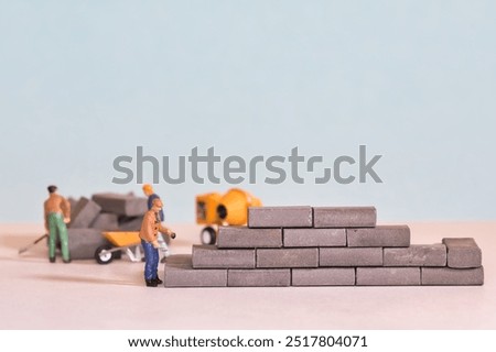 Workers, bricklayers at work on a construction site
