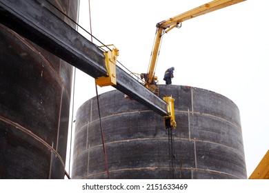 workers building a large fuel tank in winter during a snowstorm. High quality photo - Shutterstock ID 2151633469
