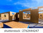 Workers are building new structure using wooden beams frames in build process