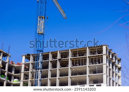 Workers are busy at a construction site, assembling a multi-story building framework.