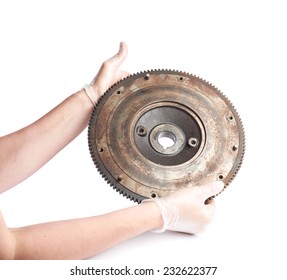 Worker's caucasian male hands in a dirty rubber gloves holding a metal engine's fragment, composition isolated over the white background