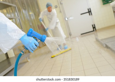 Workers Cleaning Down Factory Floor