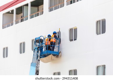 Workers Cleaning Windows On Cruise Ship In Port